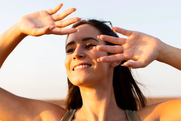 woman-covering-her-face-from-sun-while-outdoors
