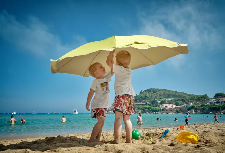 children playing under umbrella