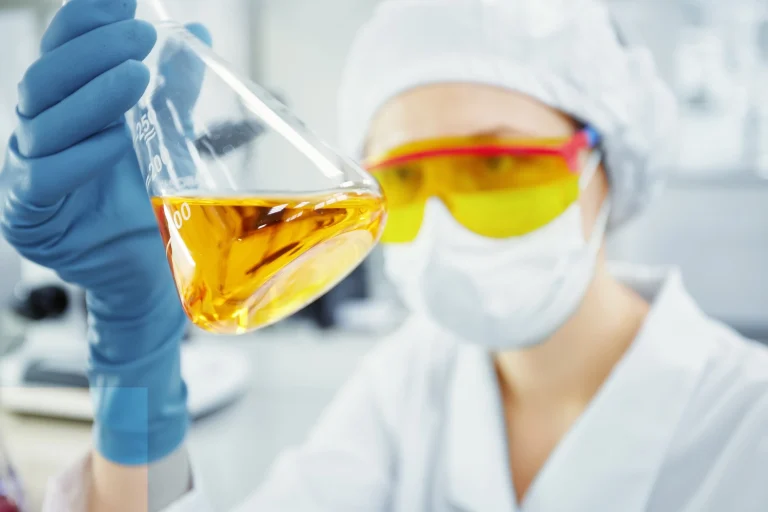1 close-up-portrait-young-woman-s-hands-holding-test-tube-with-yellow-liquid