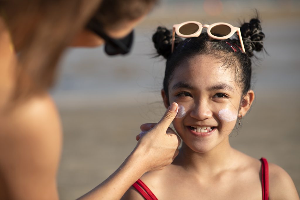 front-view-smiley-kid-with-sunscreen