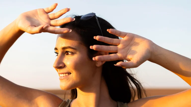 smiley-woman-outdoors-sun-covering-her-face
