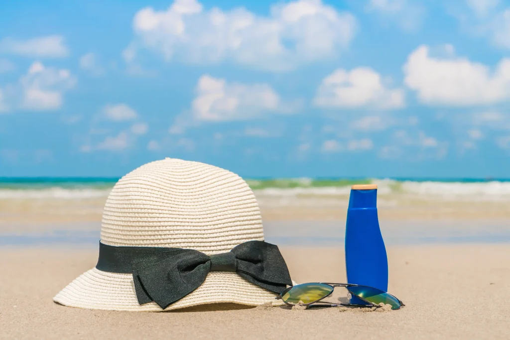 sunglasses-sun-cream-hat-white-sand-beach